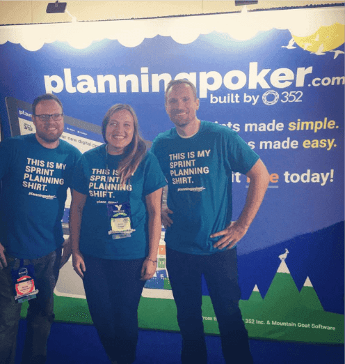 The PlanningPoker.com team at a conference booth, wearing "This Is My Sprint Planning Shirt," the brand personality Kate helped shape